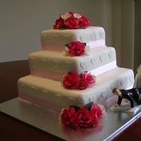My Sister's Wedding Cake This is my Sister's wedding cake i did for them......my Mum made the fruit cake for the 2 top tiers and i made a choc mud cake for the...