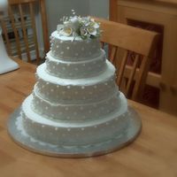 My Very First Wedding Cake! This is my first wedding and tiered cake. It was for my little sisters wedding. I had trouble getting the icing really smooth but she loved...