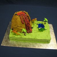 Volcano Cake I made this cake for a boy's sixth birthday. He loved it. It is a cake baked in a bowl on a 9x13 cake. I made the rocks out of fondont...