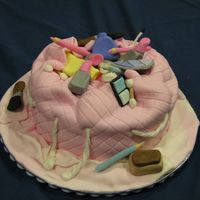 Make-Up Bag This is an 8" cake covered with fondant with make-up which is all made from fondant. It is for a 13 year old's birthday.