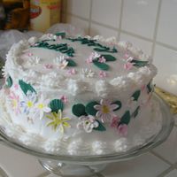Easter Cake This was a white cake with Raspberry mouse layers, covered in Buttercream and then decorated with gumpaste flowers and leaves.