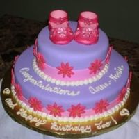 Anne-Marie's Baby Shower Pink and Purple Fondant with Fondant Daisies. The shoes are made out of gumpaste.