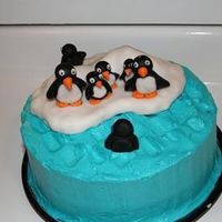 Penguin Iceburg Husband wanted to try his hand at something different. First attempt at making a penguin cake. A regular yellow cake with blue buttercream...