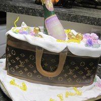 Louis Vuitton Purse Cake With Wine Bottle Louis Vuitton Purse cake with Wine Bottle and Chocolate Candy Cordials Flowers are made out of Gumpaste and the label is made from an...
