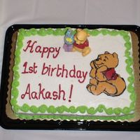 Pooh 1St Birthday This is my first ever bct!!! I messed it up a little but i don't think anybody noticed. the cake was a 2 layer yellow cake with...