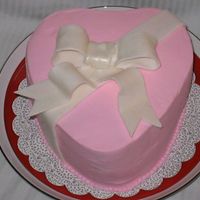 Simple Valentines Cake I made this for my husbands work. She just wanted pink buttercream icing. Its french vanilla with chocolate whipped cream. It is a fondant...