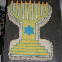 Menorah For the top of the menorah, I used a round cake pan, cut the cake in half, and stacked them. For the bottom, I cut up a sheet cake and...