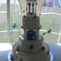 Blue Flowers And Bugs Front The bride wanted blue flowers, bugs, and a gazebo. Those are pewter Pez dispensers in the little gazebo. Flowers are fondant/gum paste (...