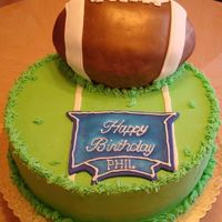 Football Fan Cake This was my first attempt at making a 3-d football cake. It finally starting looking like a football once a put the stipes on it. Then I...