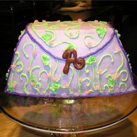 Purse Cake Made for daughters 1st birthday. Pound cake and buttercream. The clasp is a chocolate "A".