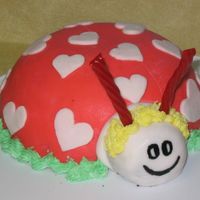 Love Bug Chocolate cake with whipped cream and maraschino cherries filling, covered and decorated with Fondant. Antennae are Twizzlers.