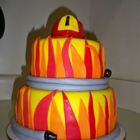 Fireman Cake Hat made from cupcake covered in fondant. Hose for border.
