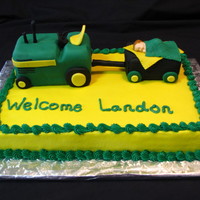 John Deere Baby Shower Cake John Deere baby shower cake with tractor. Tractor and wagon are styrofoam covered in fondant. Baby is fondant made from mold