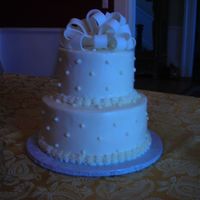 Rainbow Wedding Cake This cake is rainbow colored sour cream french vanilla with buttercream icing. Swiss dots and a fondant bow finish it off.