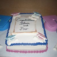 Dual Graduation Customer needed a simple cake for 2 graduations from different schools. This is a 1/2 sheet with scroll made out of fondant. Grad caps are...