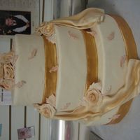Golden Wedding Cake This is a fake cake which was made for a display in a center city specialty shop. I used oval shaped pans, covered in fondant. The gold...