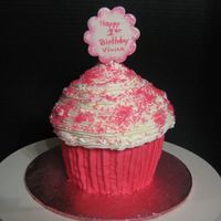 Giant Cupcake I used the wiltons giant cupcake pan for this. Made cupcake pick out of fondant and wrote on it with edible food coloring pen. Easy cake to...