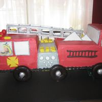 Firetruck Firetruck was made for little boy. Used 1//4 sheet cakes and stacked and carved shape. Used choc covered doughs for tires. Ladder is made...