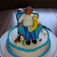Grandpa & Grandson Sculpted pound cake recliner covered in mmf. Figures mmf and 9" cake in buttercream.