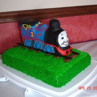 Thomas The Train Sheet cake covered in bc with 3-D train decorated like Thomas. Mmf for the face.