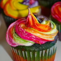 Rainbow Cupcakes Made rainbow cupcakes with BC icing for my daughters friends. It went with her rainbow theme. The cake was layers of colors so when they...