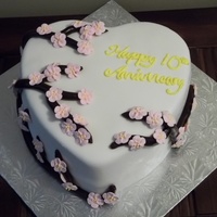 Heart-Shaped Anniversary Cake I used chocolate fondant for the branches/sticks and made the apple blossom flowers from royal icing. It's all covered with fondant....