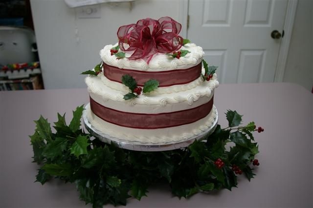 Imgp4356_Small.jpg choc. 2 tier w/ bc and artificial holly. The ribbon and holly match the bride's decorations