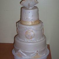 Baptism Cake Here is a cake for my God Daughter's baptism. It is covered in fondant and has gold accent paint and air brushed luster dust on the...