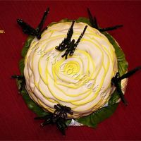 Butterflies On Fantasy Flower Cake White chocolate cake with raspberry filling & butter cream icing covered with fondant and decorated with royal color flow butterflies....