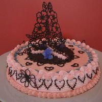 4Th Anniversary it is our anniversary cake. the centerpieces are chocolate. used lace technique by nicholas lodge. the icing is buttercream.