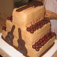 Guitar Groom's Cake chocolate buttercream frosted, stacked buttermilk devil's food cake with cherry pie filling, fopped with chocolate covered cherries...
