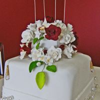 Shabby Chic This was a stacked two tier fruit cake covered in fondant. All the roses, orchids and small flowers, rose leaves and ivy leaves were made...