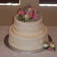 2 Tier Round Wedding Cake 14" and 10" round white cake, all buttercream. The 90 year old bride wanted a very simple, plain wedding cake.