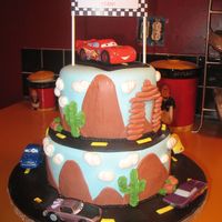 Cars Cake Two tier cars cake with lightning mcqueen and friends. Fondant with buttercream accents.
