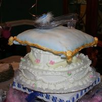 Cinderella Cake wedding cake with buttercream frosting and fondant pearls. Top layer is wedding cake with oreo filling and fondant.