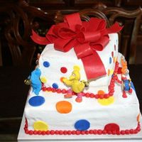 Sesame Street Red chocolate bow, fondant polka dots on buttercream. Butter cake with oreo filling.