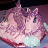 Pegasus I made this cake for my four year olds birthday. Fondant covered cake with chocolate wings and hair. Cotton candy clouds.