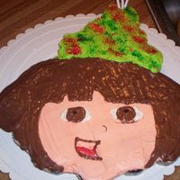 Dora Cupcake Cake chocolate cupcakes, buttercream frosting, and chocolate eyes and hair. For the hat I used edible glitter.