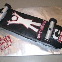 Skateboard An exact replica of the underside of my grandson's skateboard. Wheels are Oreos and chuck, cake top and decals are fondant. Cake iced...