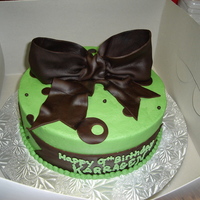Green And Brown Buttercream with fondant bow and accents.
