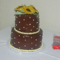 Bridal Shower Cake Fondant sunflowers with chocolate ganache frosting. Piped with buttercream. Cake was white with cheesecake and fresh strawberries as the...