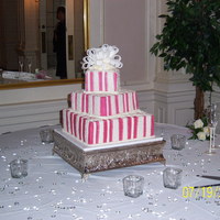 Wedding butter cream icing w/the fondant striped and gumpaste bow.
