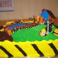 Construction Cake I had fun with this cake. I used brownie crumbs for dirt and candy rocks. The house is made of graham crackers held with royal icing.