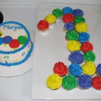 1St Birthday Cake Vanilla cake with vanilla buttercream icing. 6" smash cake with 24 mini cuppies. I tried to fit them on the same board but I didn'...