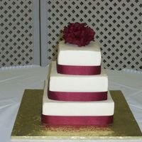 Wedding Cake A wedding cake I did with satin ribbon and silk hydrangeas. Still working on getting the icing really smooth but sooo much better after...