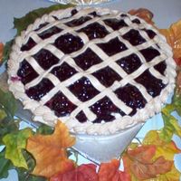 "blueberry Pie" Cake This is a chocolate cake baked in a large pie plate decorated in crust coloured BC and blueberry pie filling on top and in the middle.