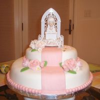 Kiana's 1St Communion White cake with buttercream frosting and raspberry filling. All decorations were made with MMF. The 1st communion figurine was stored...
