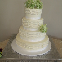 Walker Wedding Cake Four tiers in buttercream with fondant pearl drapes. This is a variation of a photo bride brought to me done by another decorator for...