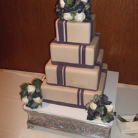 James Wedding Cake Four tiers in taupe to match bride's gown with dark lapis accents on the cake.