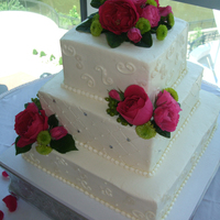 Patterson Wedding Three square tiers in buttercream with piping and diamond pattern, fresh flowers provided by bride. Thanks for looking.